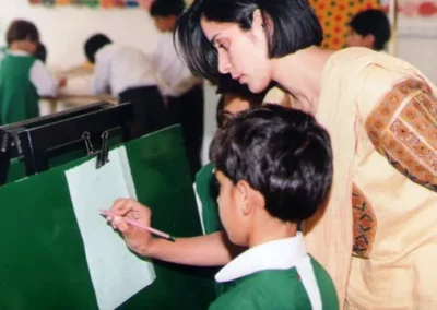 A child getting some guidance with his artwork at Pearl Valley Public School